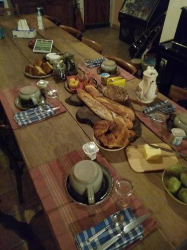 a wooden table with food on top of it at Au bois de mon coeur in Foameix