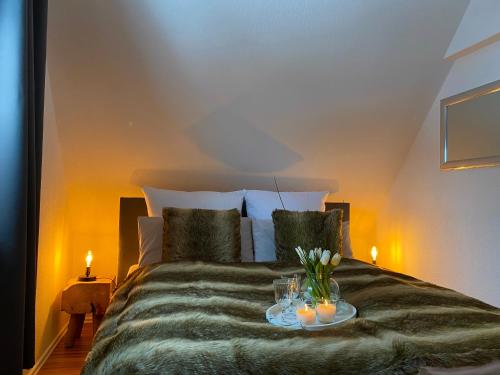 a bedroom with a bed with a tray with flowers on it at Pension Haus am Wald in Braunlage