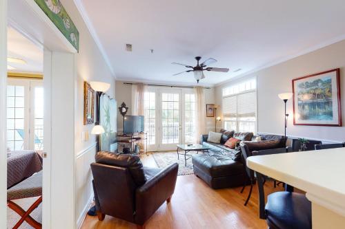 a living room with a couch and a table at Pavilion Watch #1A in Folly Beach