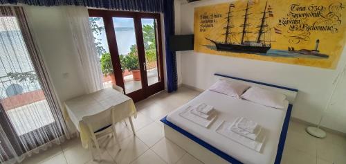 a small room with a bed and a boat on the wall at Apartment Buco in Starigrad-Paklenica