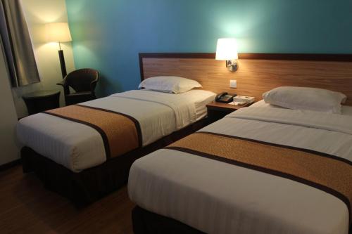 Posteľ alebo postele v izbe v ubytovaní TD Lodge Kota Belud