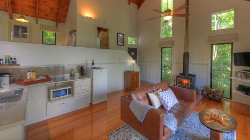 a living room with a couch and a stove at Montville Misty View Cottages in Montville