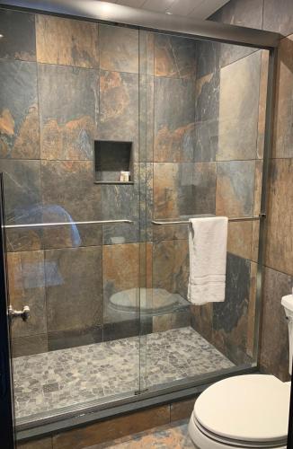 a bathroom with a shower with a toilet at The Barnstead Inn in Manchester Center