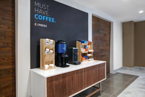 a coffee shop with a sign that says must have coffee at Holiday Inn Express - Milwaukee Downtown by IHG in Milwaukee
