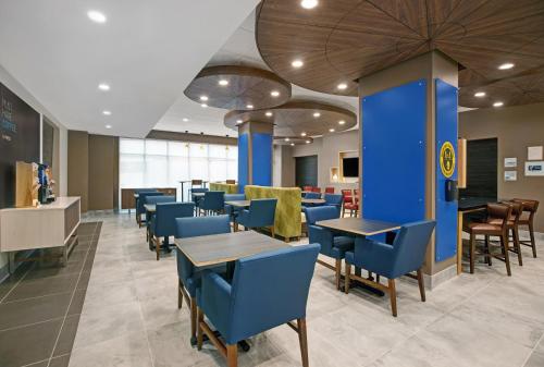 a dining room with blue chairs and tables at Holiday Inn Express - Milwaukee Downtown by IHG in Milwaukee