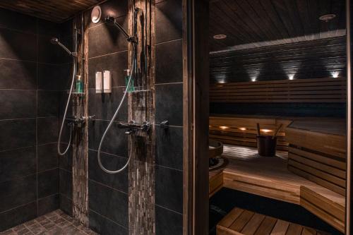 a bathroom with a shower and a sauna at Beana Laponia - Wilderness boutique hotel with safaris in Meltaus