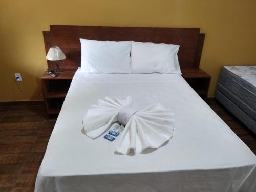 Säng eller sängar i ett rum på Pousada Bougainville