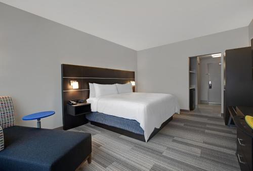a hotel room with a bed and a couch at Holiday Inn Express - Milwaukee Downtown by IHG in Milwaukee