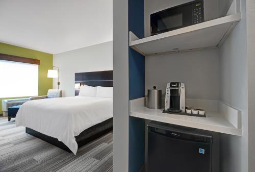 a hotel room with a bed and a microwave at Holiday Inn Express - Milwaukee Downtown by IHG in Milwaukee