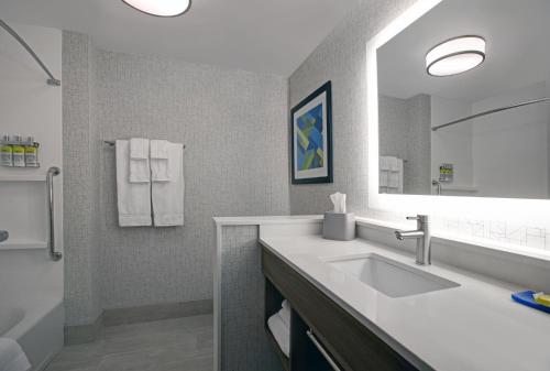 a bathroom with a sink and a mirror at Holiday Inn Express - Milwaukee Downtown by IHG in Milwaukee