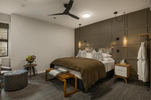 a bedroom with a large bed and a ceiling fan at 14th Lane Urban Hotel in Blenheim
