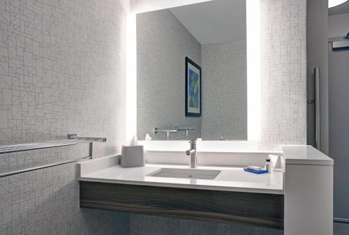 a bathroom with a sink and a mirror at Holiday Inn Express - Milwaukee Downtown by IHG in Milwaukee