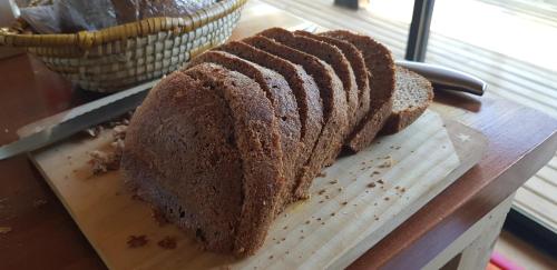 a loaf of bread sitting on a cutting board at Vivelodge in Las Trancas