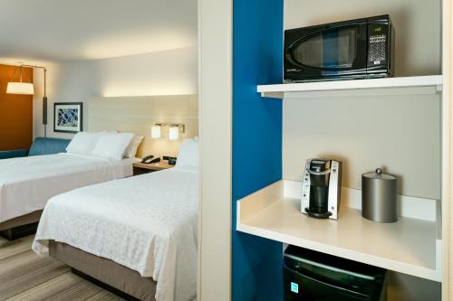 a hotel room with two beds and a microwave at Holiday Inn Express & Suites - Medford by IHG in Medford