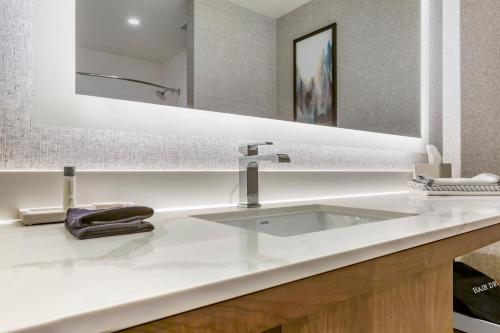 a bathroom with a white sink and a mirror at Hotel Centro Sonoma Wine Country, Tapestry Collection Hilton in Rohnert Park