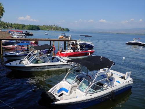 a group of boats are docked in the water at Club Cadena in Acapulco
