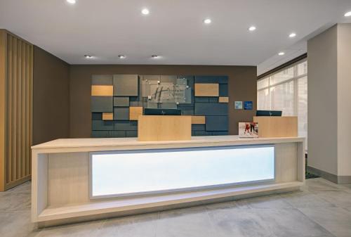 an empty lobby with a large white sign at Holiday Inn Express - Milwaukee Downtown by IHG in Milwaukee