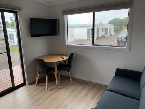 a small living room with a table and a couch at Portland Holiday Village in Portland