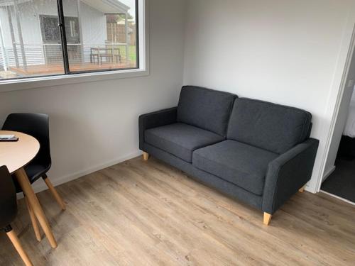a living room with a couch and a table at Portland Holiday Village in Portland