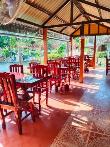 a group of tables and chairs in a restaurant at Boonya Resort Koh Chang in Ko Chang