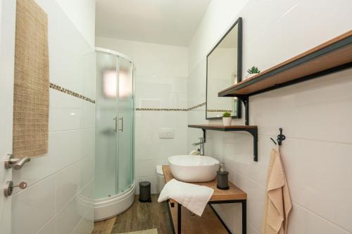 a bathroom with a sink and a glass shower at Mobile home Rock Samphire 1 in Pakoštane