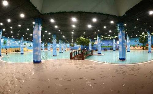 a large pool with blue columns in a building at BOM HOMES- Vinhomes Times City- Service Apartment in Hanoi