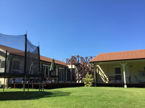 a house with a patio and a grass yard at guest house annsea in Ishigaki Island