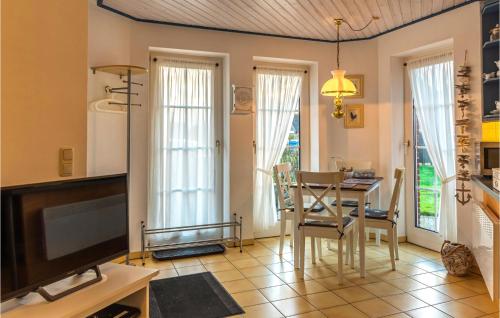 un salon avec une table et une télévision dans l'établissement Beautiful Apartment In Friedrichskoog, à Friedrichskoog