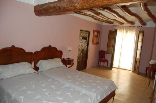 Una cama o camas en una habitación de Turismo Rural La Ojinegra