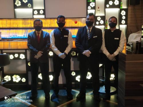 a group of men standing in front of a bar at Hotel Plaza in Mumbai