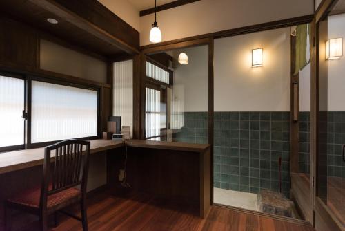 a room with a desk and a chair in a room at Rikyu-an Machiya House in Kyoto