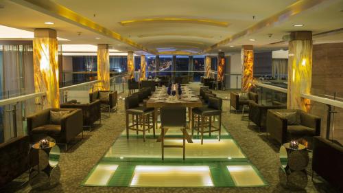 a dining room with a long table and chairs at Radisson Blu Hotel Pune Kharadi in Pune