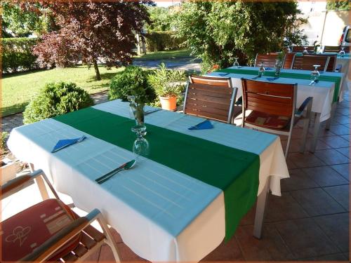 a table with a blue and green table cloth at Csipke Hotel in Kiskunhalas