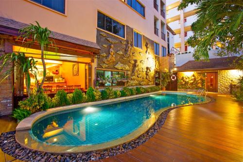 a swimming pool in the middle of a building at Orchid Garden Hotel Patong in Patong Beach