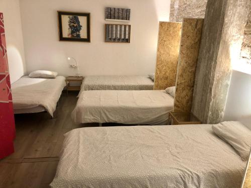 a room with four beds in a room at Art&Flats Hostel in Valencia