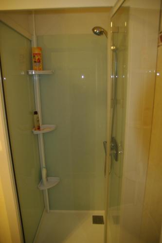 a bathroom with a shower with a glass door at Maison hyper-centre Bagnères de Luchon in Luchon