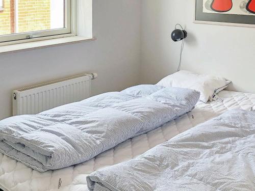 two beds sitting next to each other in a bedroom at Holiday Home Banedæmningen II in Hejls