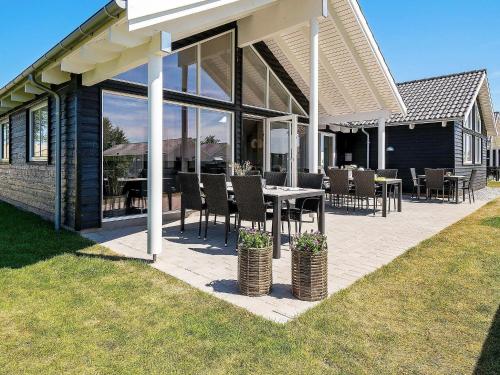 a patio with a table and chairs on a house at 16 person holiday home in Hasselberg in Kappeln