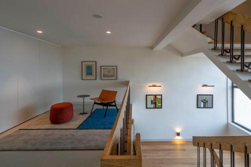 a room with a staircase with a chair and a desk at Parador de Aiguablava in Begur