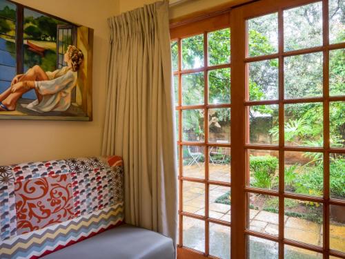 a living room with large windows and a couch at Fouriesburg Country Inn in Fouriesburg