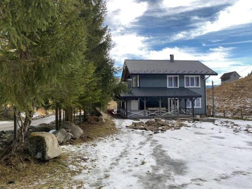 a house with snow on the ground in front of it at Дзембронія in Dzembronia