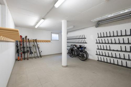 a room with a bunch of skis on the wall at Apartments Maiskogelblick in Piesendorf