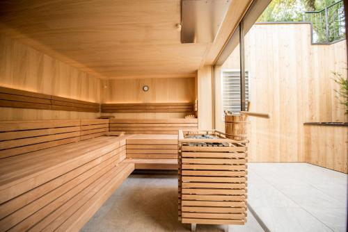 an empty sauna with wood paneling and a window at Dining & Living Alpenrose in Bressanone