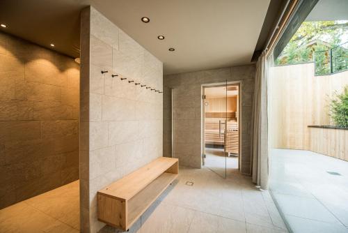 a hallway with a wooden bench in a house at Dining & Living Alpenrose in Bressanone
