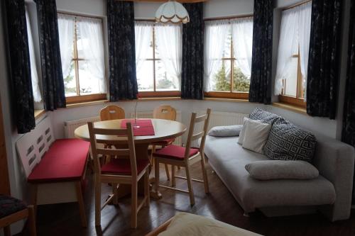 a living room with a table and a couch at Haus Alpengruss in Sankt Leonhard im Pitztal