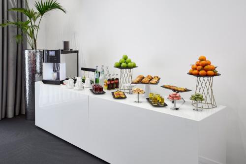 a white counter with a bunch of food on it at LÉGÈRE HOTEL Luxembourg in Luxembourg