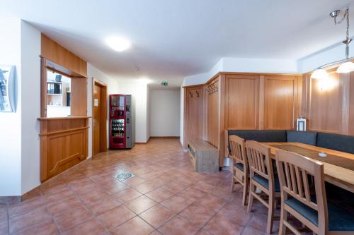a kitchen with a table and chairs in a room at Apartments Maiskogelblick in Piesendorf