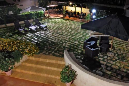 an overhead view of a patio with chairs and an umbrella at DaLucia in Torre Vado