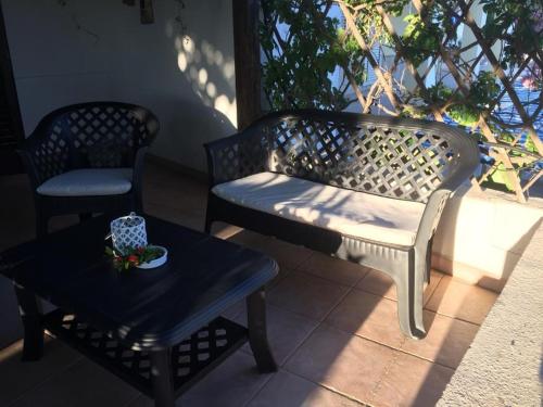 a bench and a coffee table on a patio at DaLucia in Torre Vado