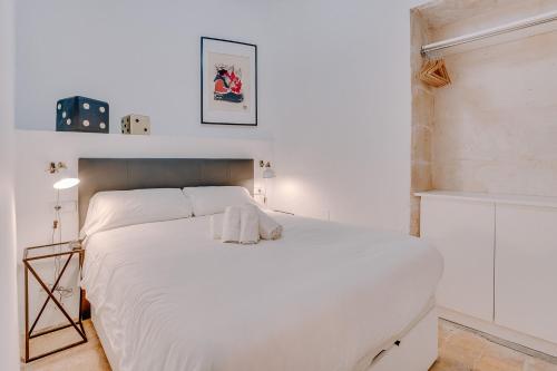 a white bedroom with a large white bed at Vintage Palma Palace Apartments TI by PriorityVillas in Palma de Mallorca